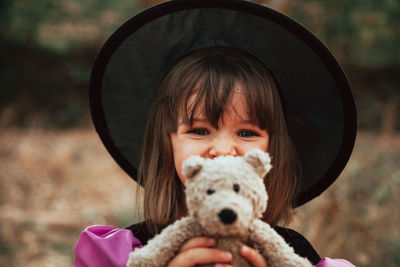 Portrait of cute girl holding camera