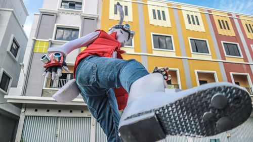 Low angle view of man wearing costume against building