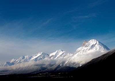 Scenic view of snowcapped mountain against blue sky