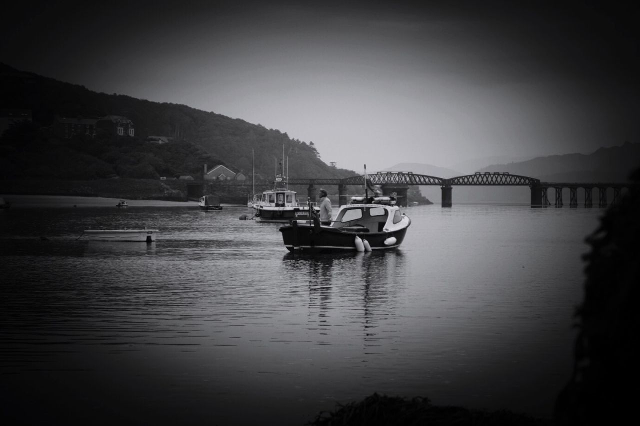 water, transportation, nautical vessel, mode of transportation, sky, vignette, nature, waterfront, tranquility, no people, reflection, beauty in nature, tranquil scene, clear sky, sea, outdoors, mountain, travel, moored, passenger craft