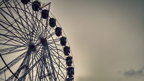 Low angle view of ferris wheel against clear sky