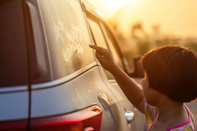 Rear view of woman in car