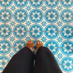 Low section of woman standing on tiled floor