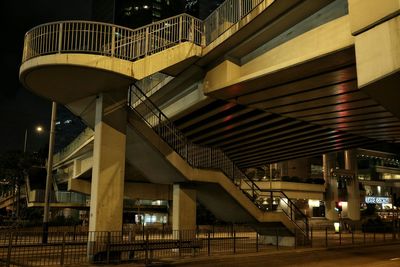 Steps and bridge in city at night