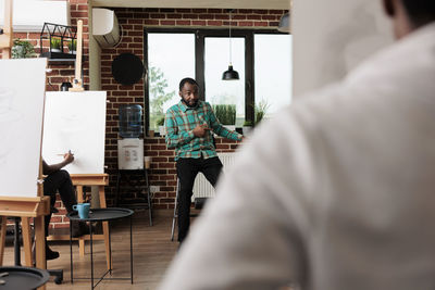 Rear view of man working at office