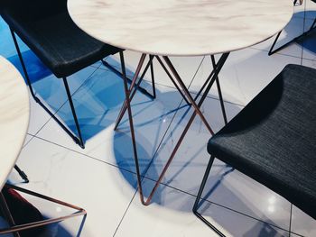 High angle view of chairs on table