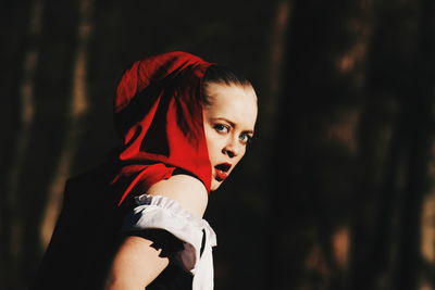 Portrait of surprised woman standing in forest