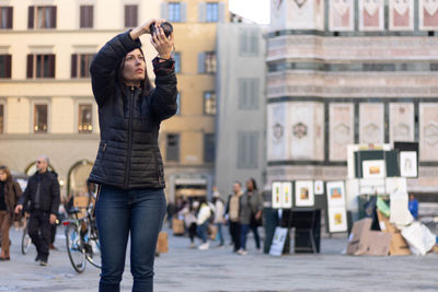 Portrait of photographer woman unfocused background at florence, italy. 50mm lens