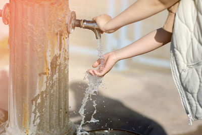 Midsection of man washing hands