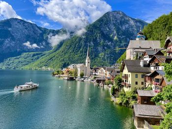 Scenic view of lake and mountains against sky - this is hallstatt