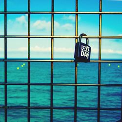 Information sign by window against blue sky