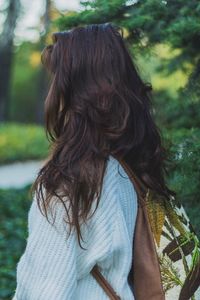 Side view of young woman wearing bag