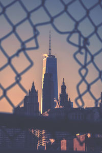 Reflection of buildings in city during sunset