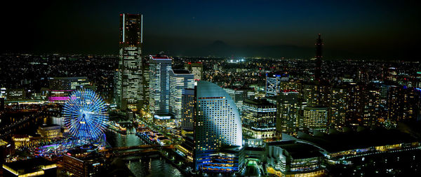 High angle view of city lit up at night