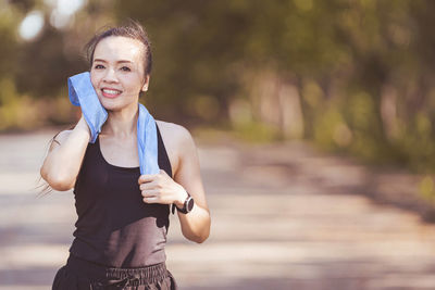 Portrait of smiling young woman standing outdoors