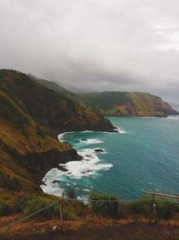 Scenic view of sea and mountains against sky