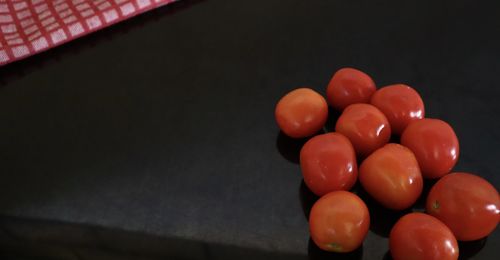 High angle view of tomatoes on table against black background
