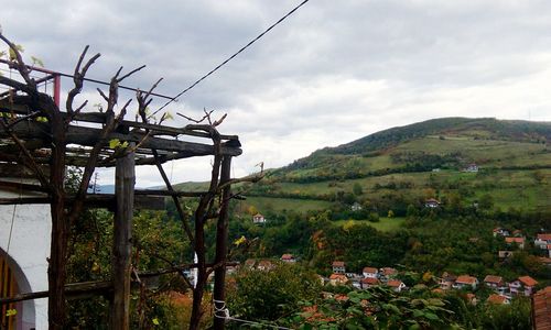 Built structure on countryside landscape against cloudy sky