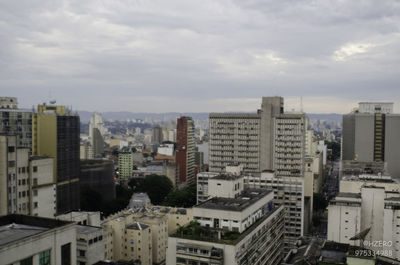 High angle view of cityscape against cloudy sky