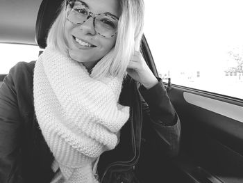 Portrait of happy young woman in car