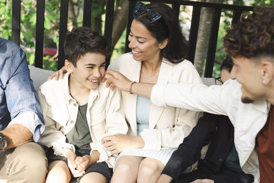 Happy family sitting together at patio in back yard