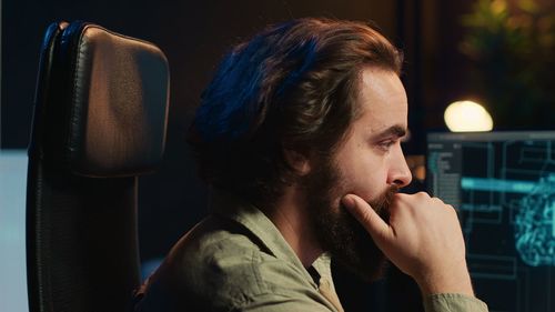 Thoughtful young man smoking cigarette