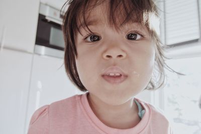 Portrait of cute baby girl at home