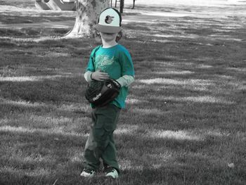 Full length of boy standing on grassy field