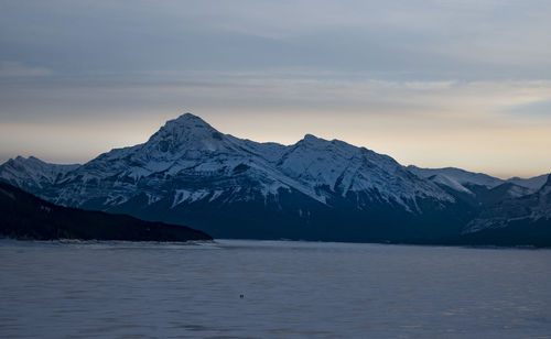 Scenic view of snowcapped mountains against sky during winter