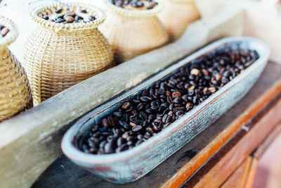 Close-up of roasted coffee beans in containers on table at market