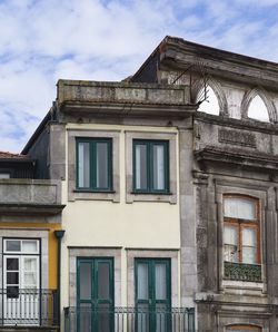 Low angle view of old building against cloudy sky