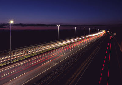 High angle view of light trails on highway at night