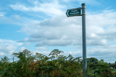 Low angle view of sign against sky