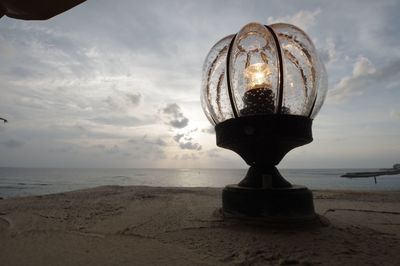 Sea shore against sky during sunset