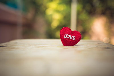 Close-up of heart shape on red table