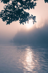 Scenic view of river against sky during sunrise