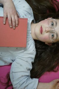 High angle view of woman lying in bedroom