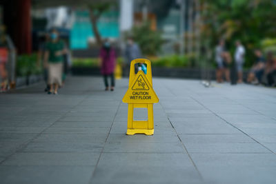 Caution wet floor sign or orchard road, singapore. horizontal shot with copy space