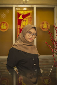 Portrait of young woman standing outdoors