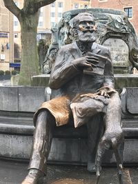 Statue against city