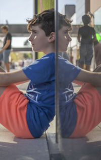 Side view of young man standing in gym