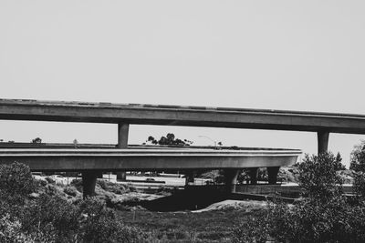 Bridge on field against clear sky