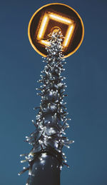 Low angle view of illuminated christmas tree against sky