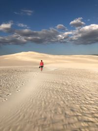 Man on desert against sky