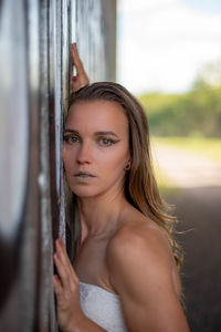 Portrait of beautiful young woman standing outdoors