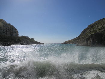 Scenic view of sea against clear blue sky