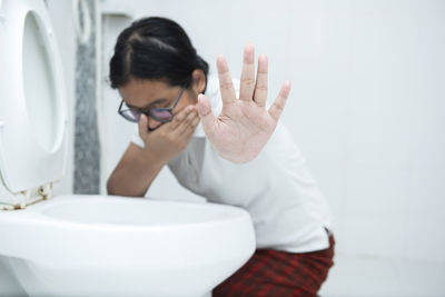 Midsection of man in bathroom