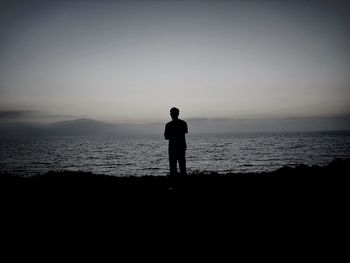 Silhouette of woman standing on beach