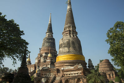 Low angle view of buddhist temple against clear blue sky