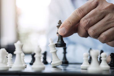 Close-up of man playing with chess